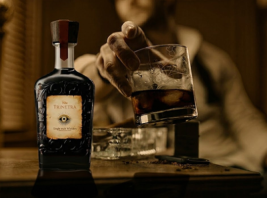 Trinetra Whisky single malt with rich color and premium presentation